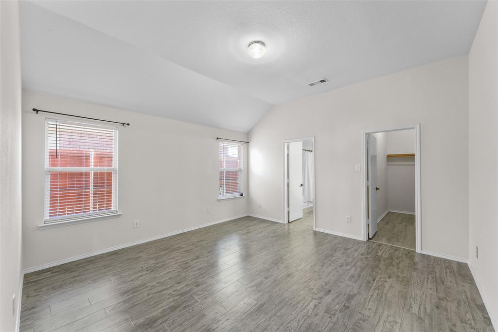 2124 Hickory Ridge Drive Mesquite, TX 75181 - Photo 7 of 16 an empty room with wooden floor and windows