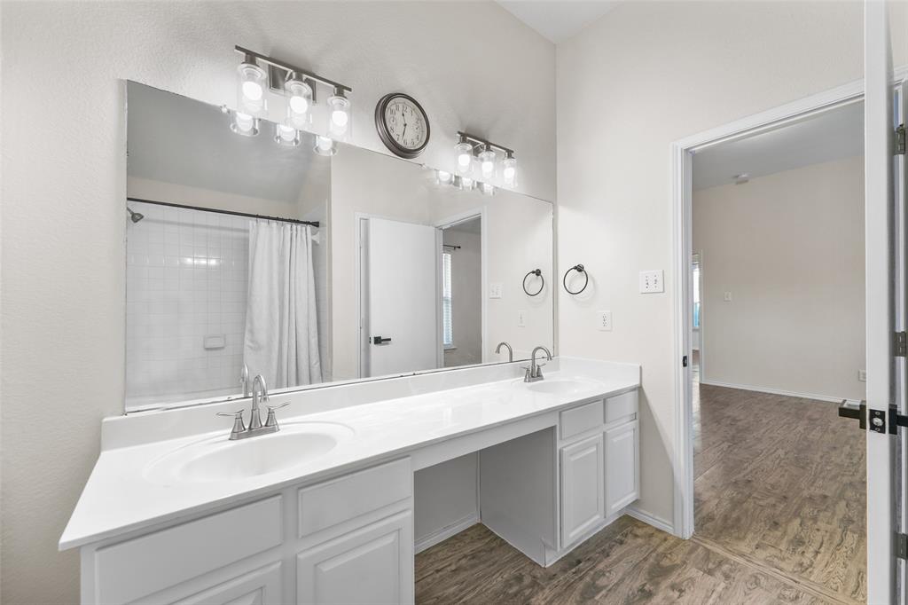 2124 Hickory Ridge Drive Mesquite, TX 75181 - Photo 8 of 16 a bathroom with a double vanity sink and a mirror