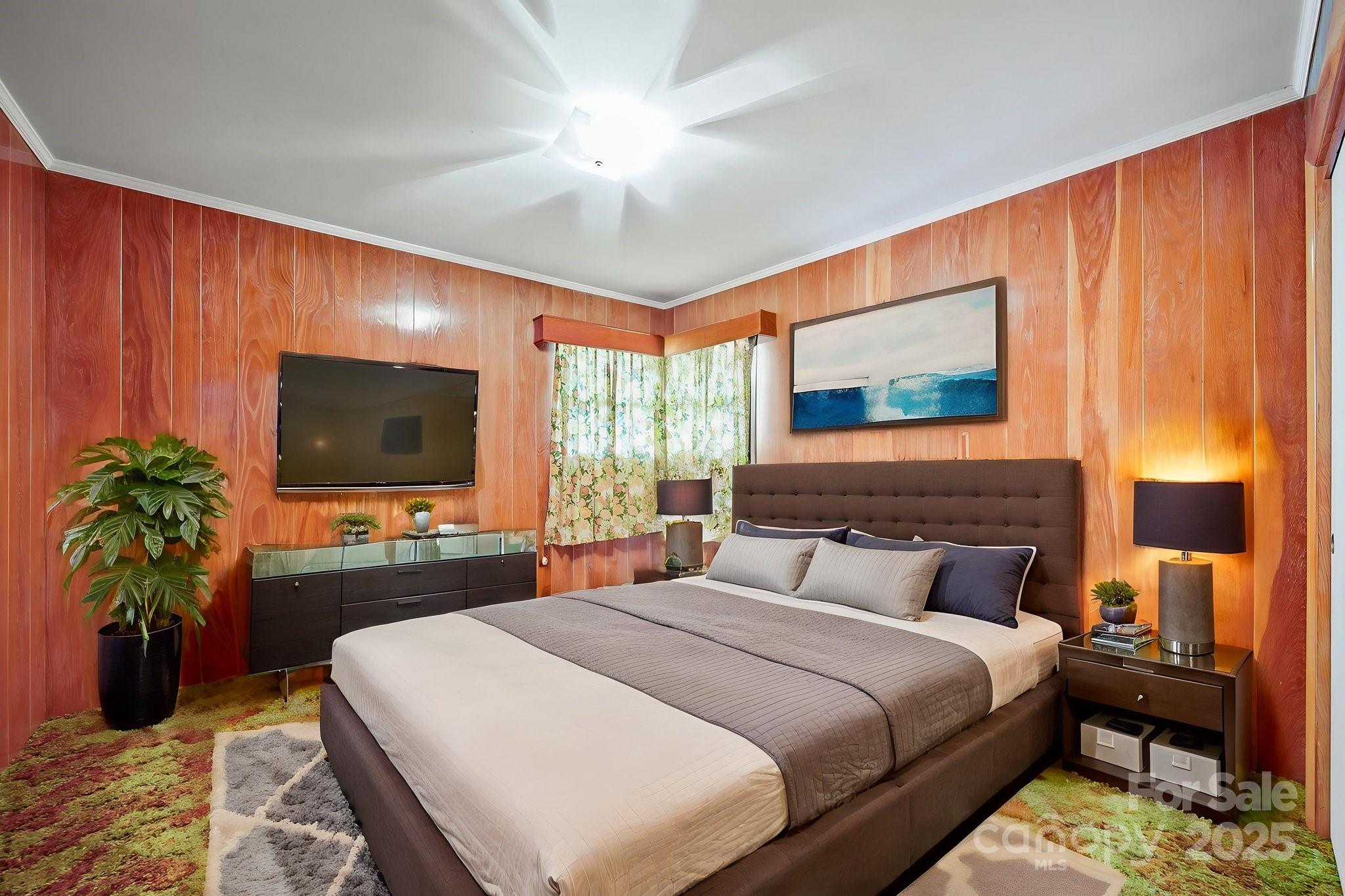 3710 Camden Road Marshville, NC 28103 - Photo 25 of 38 a bedroom with a large bed and a flat tv screen on dresser