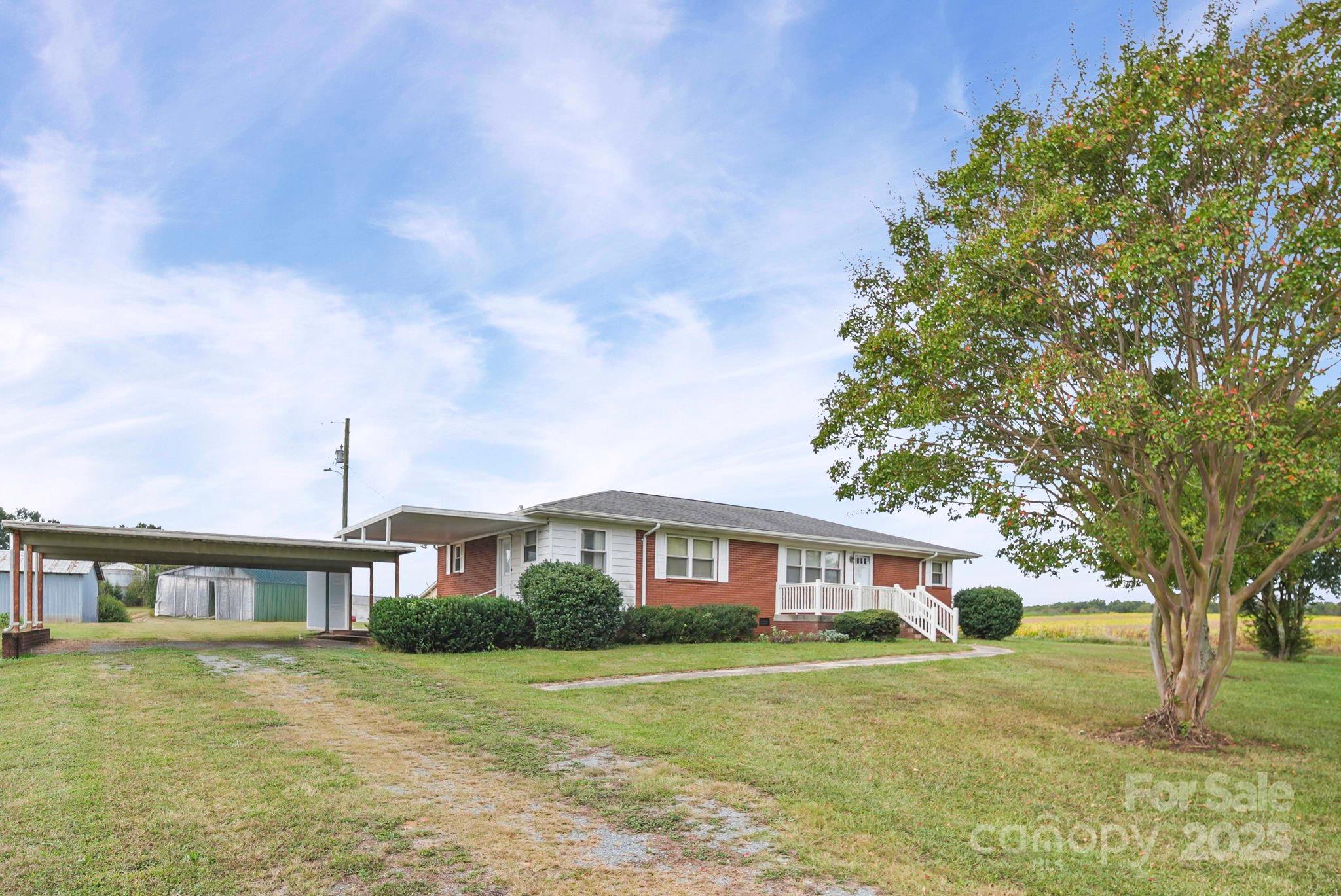 3710 Camden Road Marshville, NC 28103 - Photo 3 of 38 a front view of a house with a garden