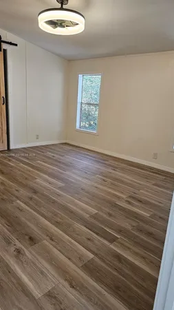 a view of a room with wooden floor