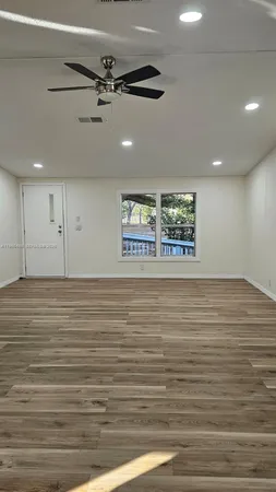 a kitchen with granite countertop a stove and a wooden floor