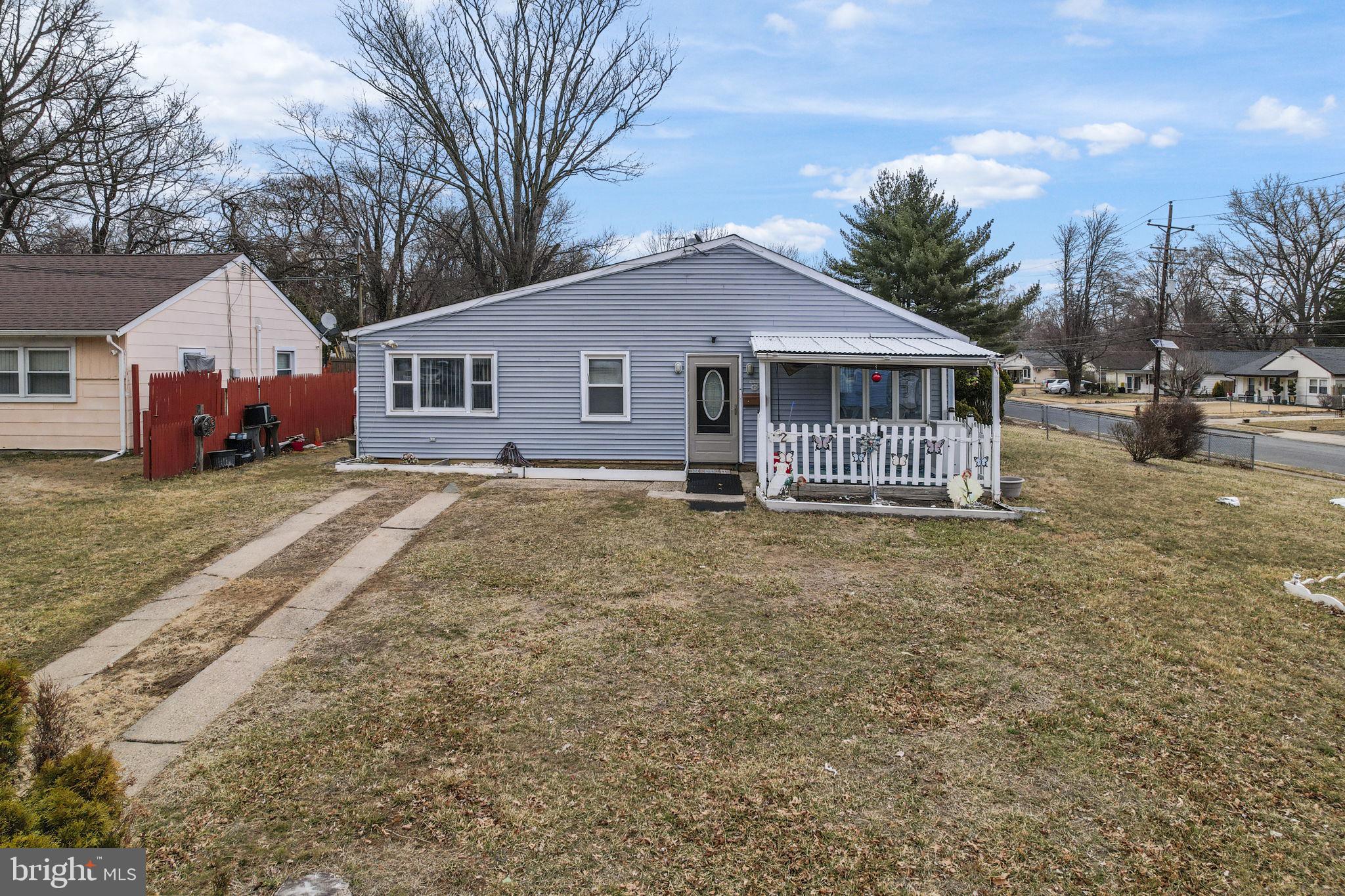 a front view of a house with a yard covered in snow