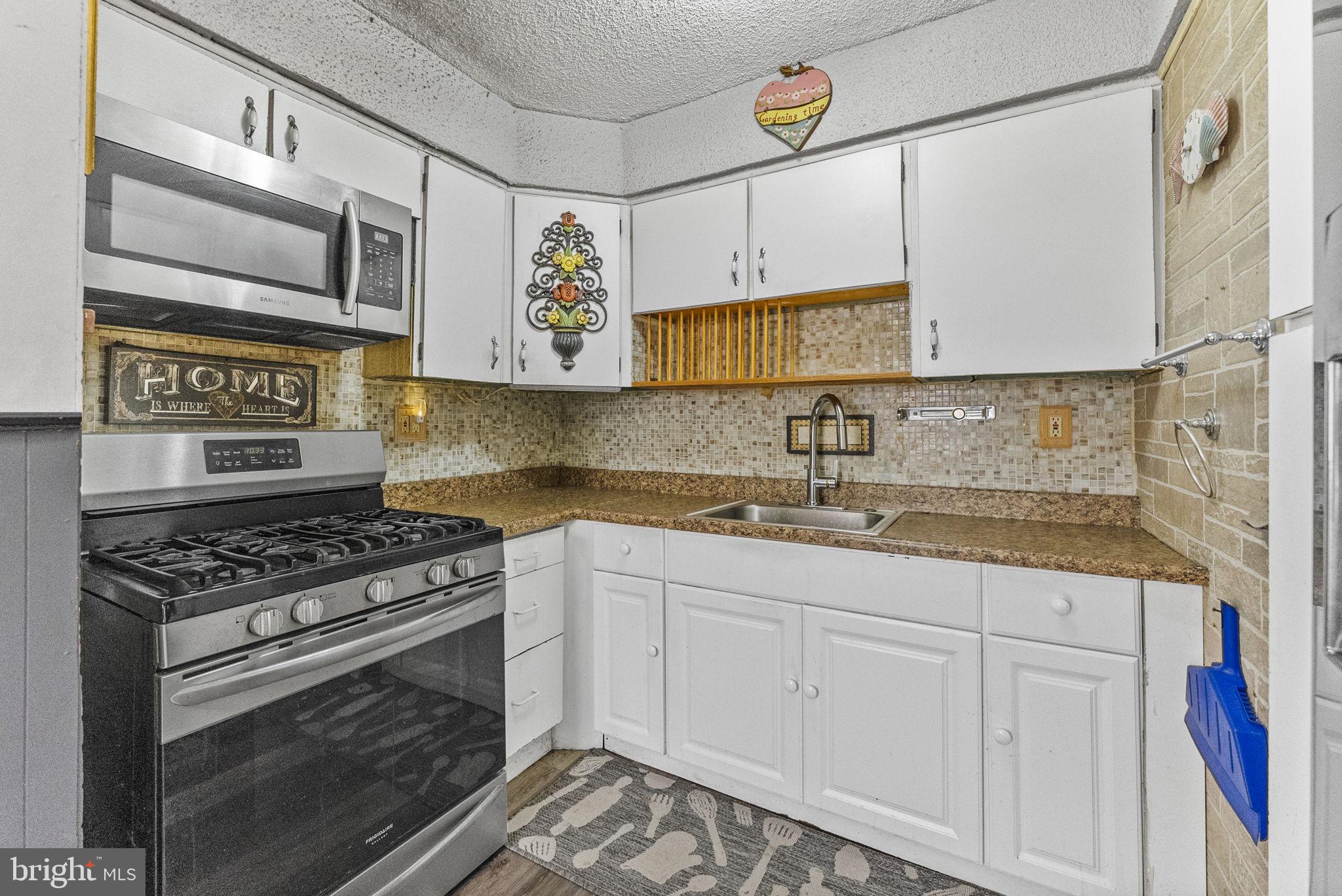 2 Dorset Drive Ewing, NJ 08618 - Photo 7 of 40 a kitchen with stainless steel appliances granite countertop a stove and a sink