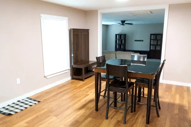 a view of a dining room with furniture and wooden floor