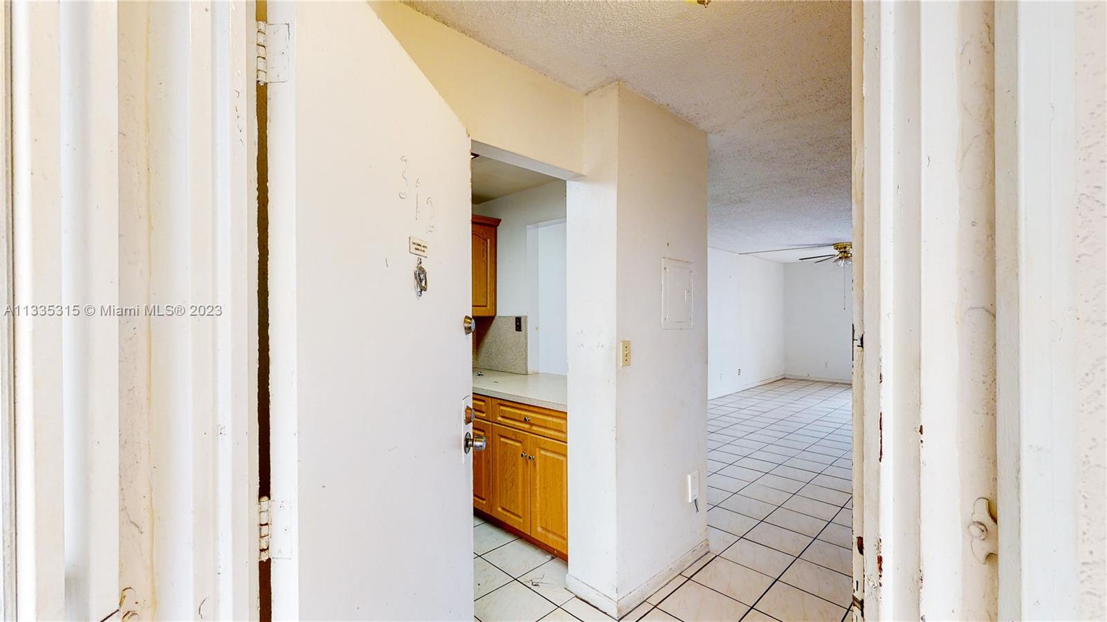 1750 West 46th Street, Unit 312 Hialeah, FL 33012 - Photo 15 of 41 a view of a bedroom from a hallway