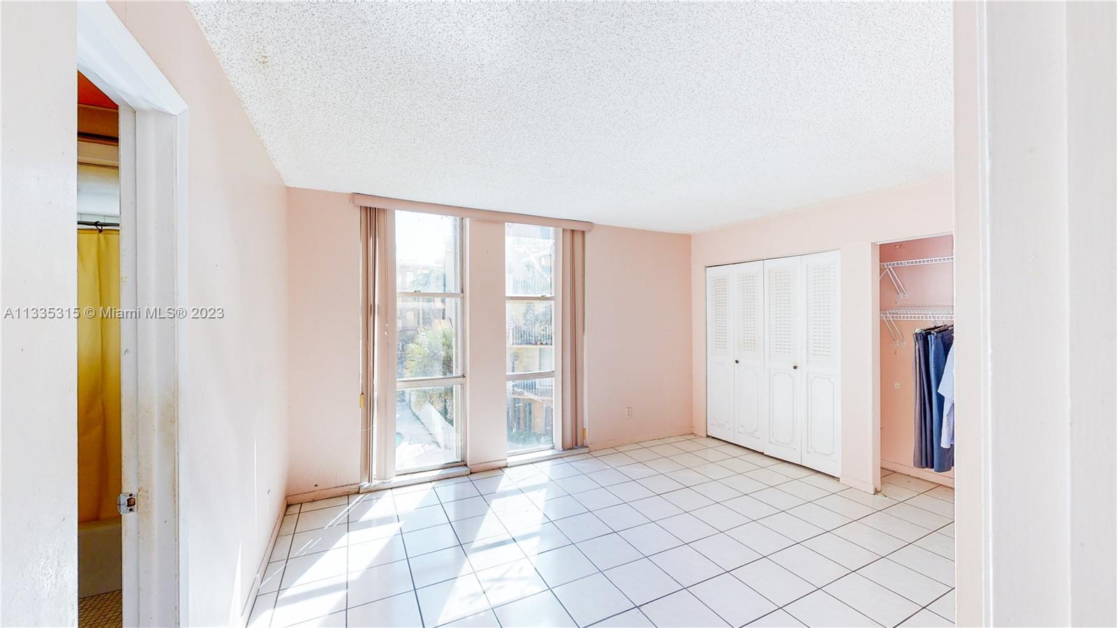 1750 West 46th Street, Unit 312 Hialeah, FL 33012 - Photo 23 of 41 a view of an empty room and window