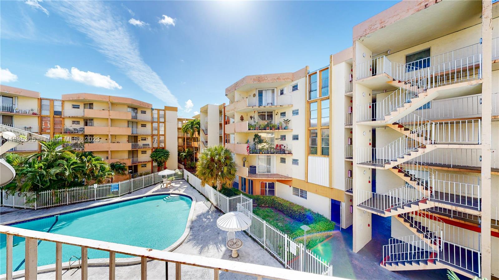 1750 West 46th Street, Unit 312 Hialeah, FL 33012 - Photo 27 of 41 a balcony with lots of green space and plants