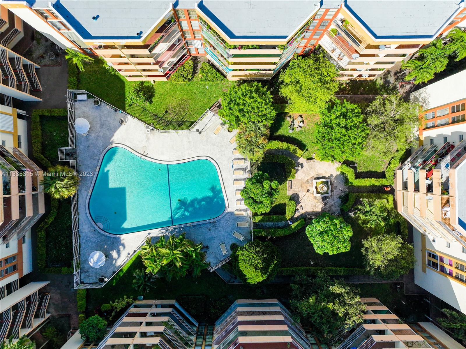 1750 West 46th Street, Unit 312 Hialeah, FL 33012 - Photo 36 of 41 an aerial view of a house with a yard and garden