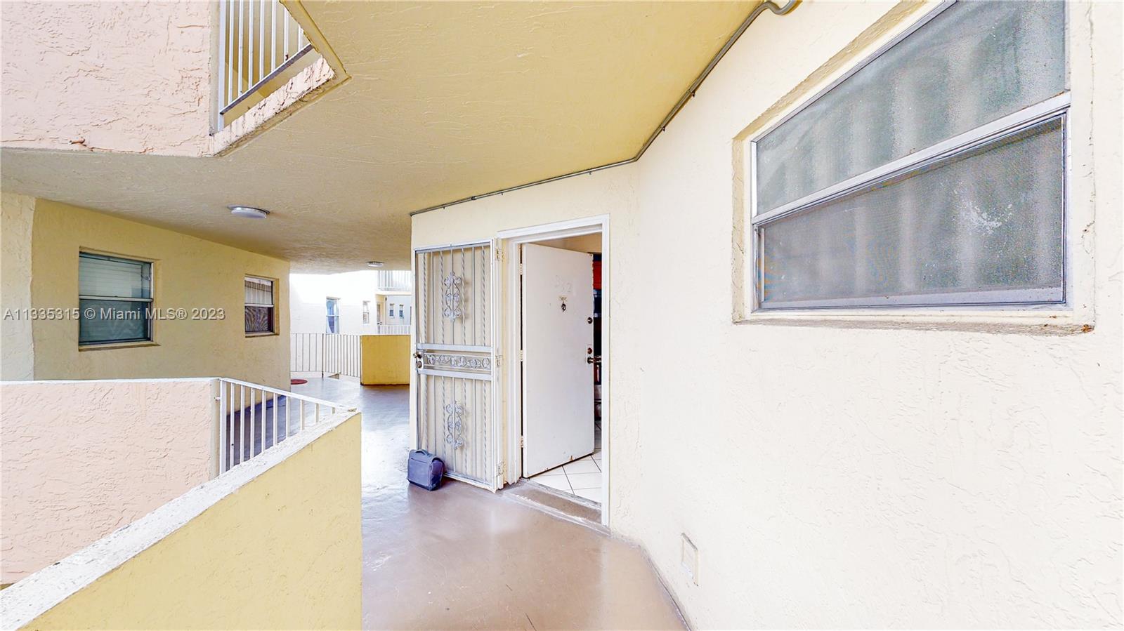 1750 West 46th Street, Unit 312 Hialeah, FL 33012 - Photo 5 of 41 a view of a living room with a large window