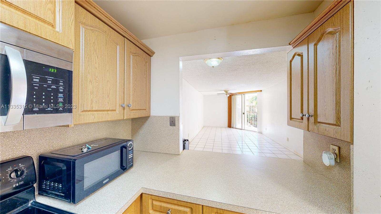 1750 West 46th Street, Unit 312 Hialeah, FL 33012 - Photo 8 of 41 a view of kitchen with furniture and large window