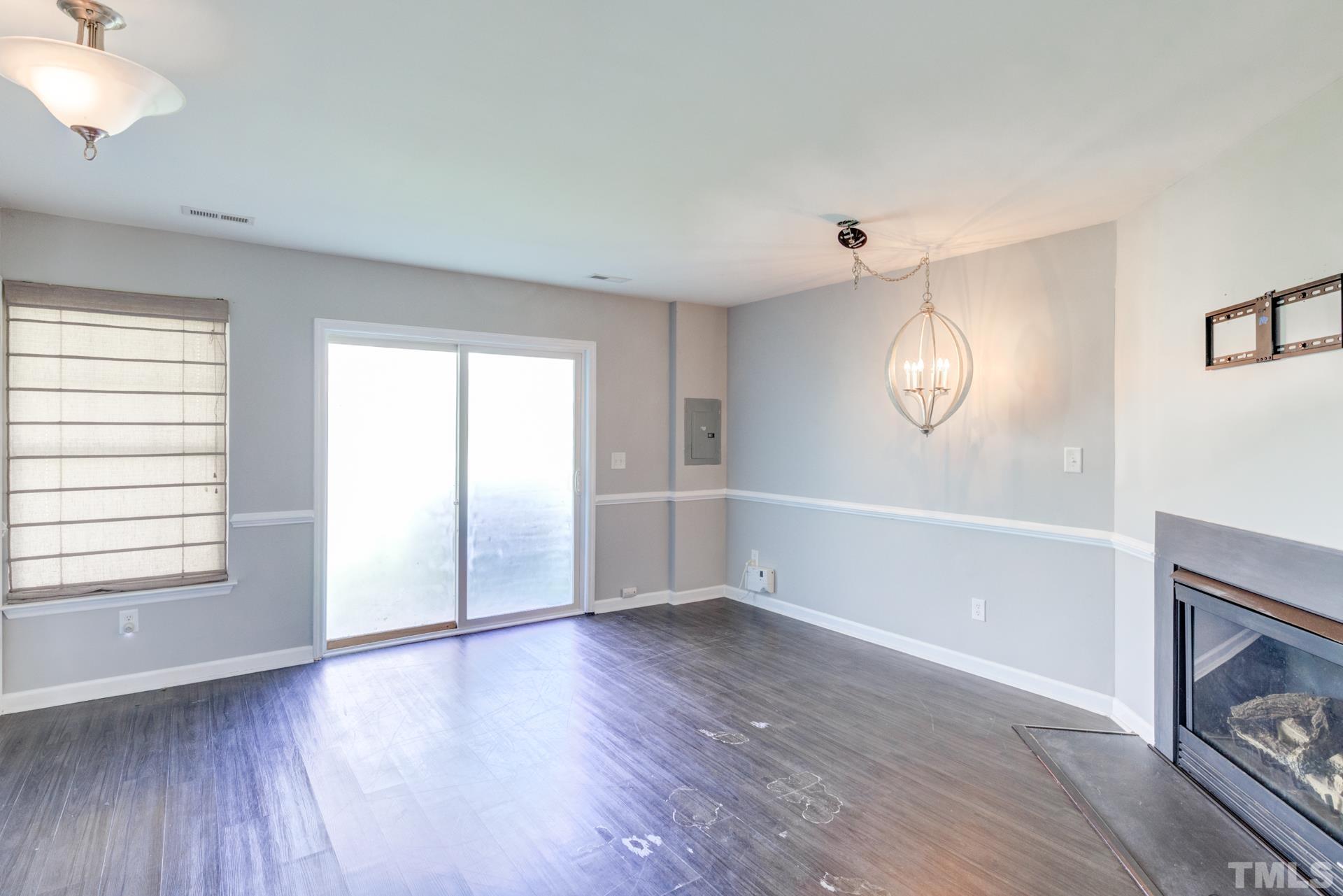 4911 Midstone Lane Raleigh, NC 27610 - Photo 14 of 28 an empty room with wooden floor mirror and windows