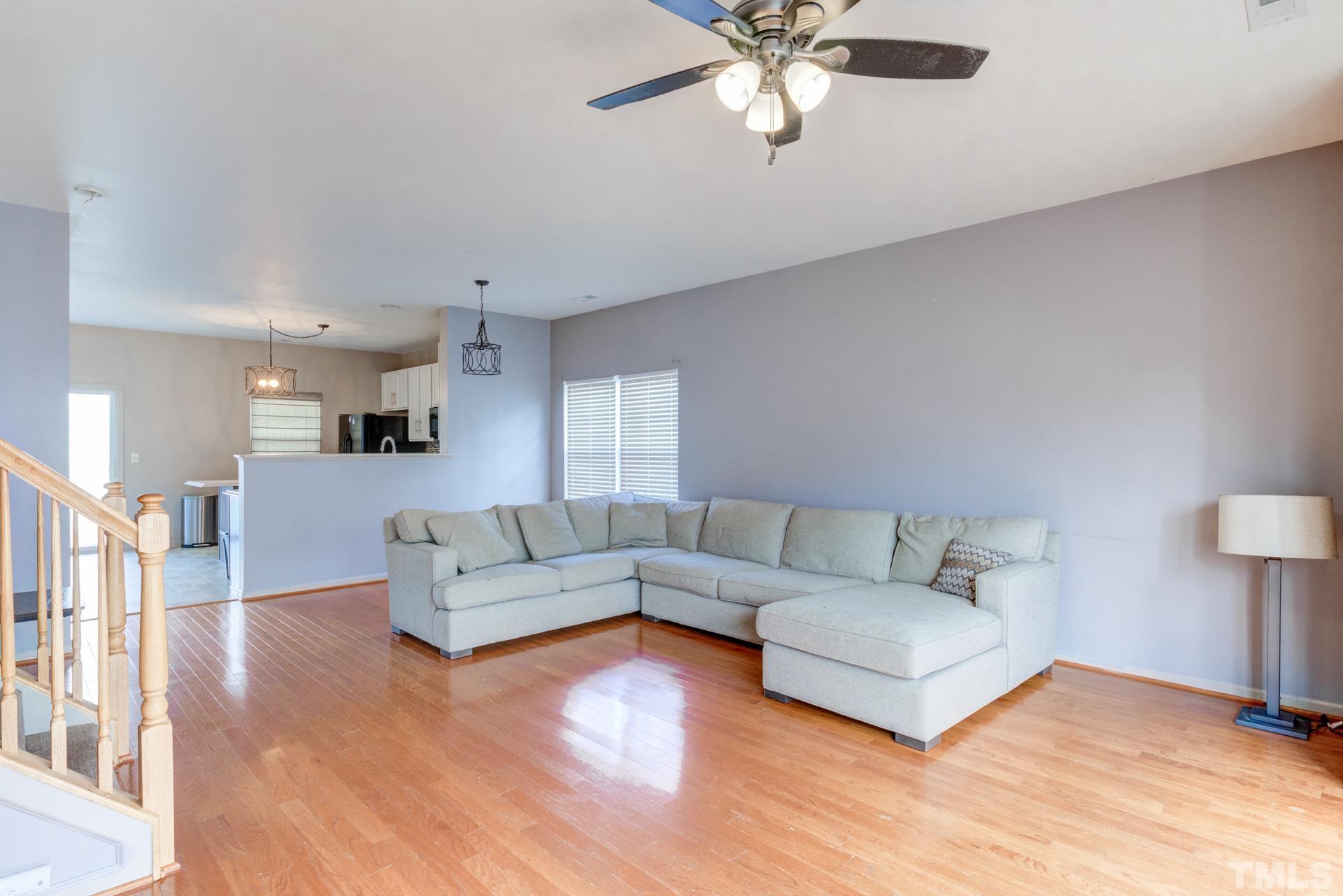 4911 Midstone Lane Raleigh, NC 27610 - Photo 16 of 28 a living room with furniture and a wooden floor