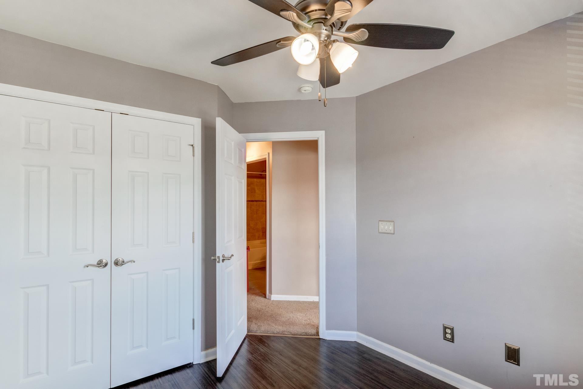 4911 Midstone Lane Raleigh, NC 27610 - Photo 18 of 28 an empty room with wooden floor closet and windows