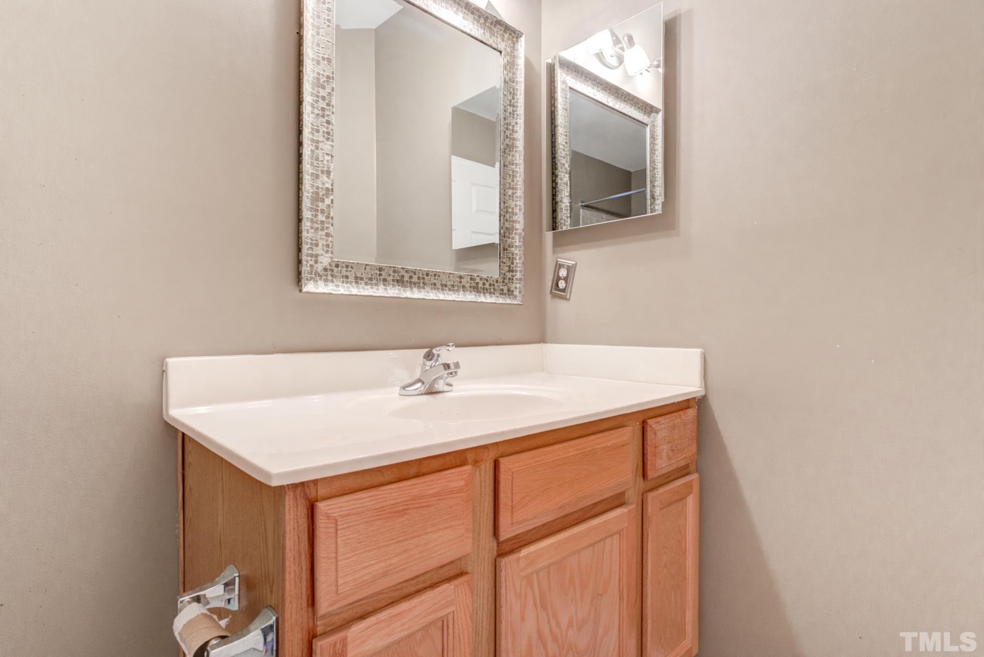4911 Midstone Lane Raleigh, NC 27610 - Photo 20 of 28 a bathroom with a sink vanity and mirror