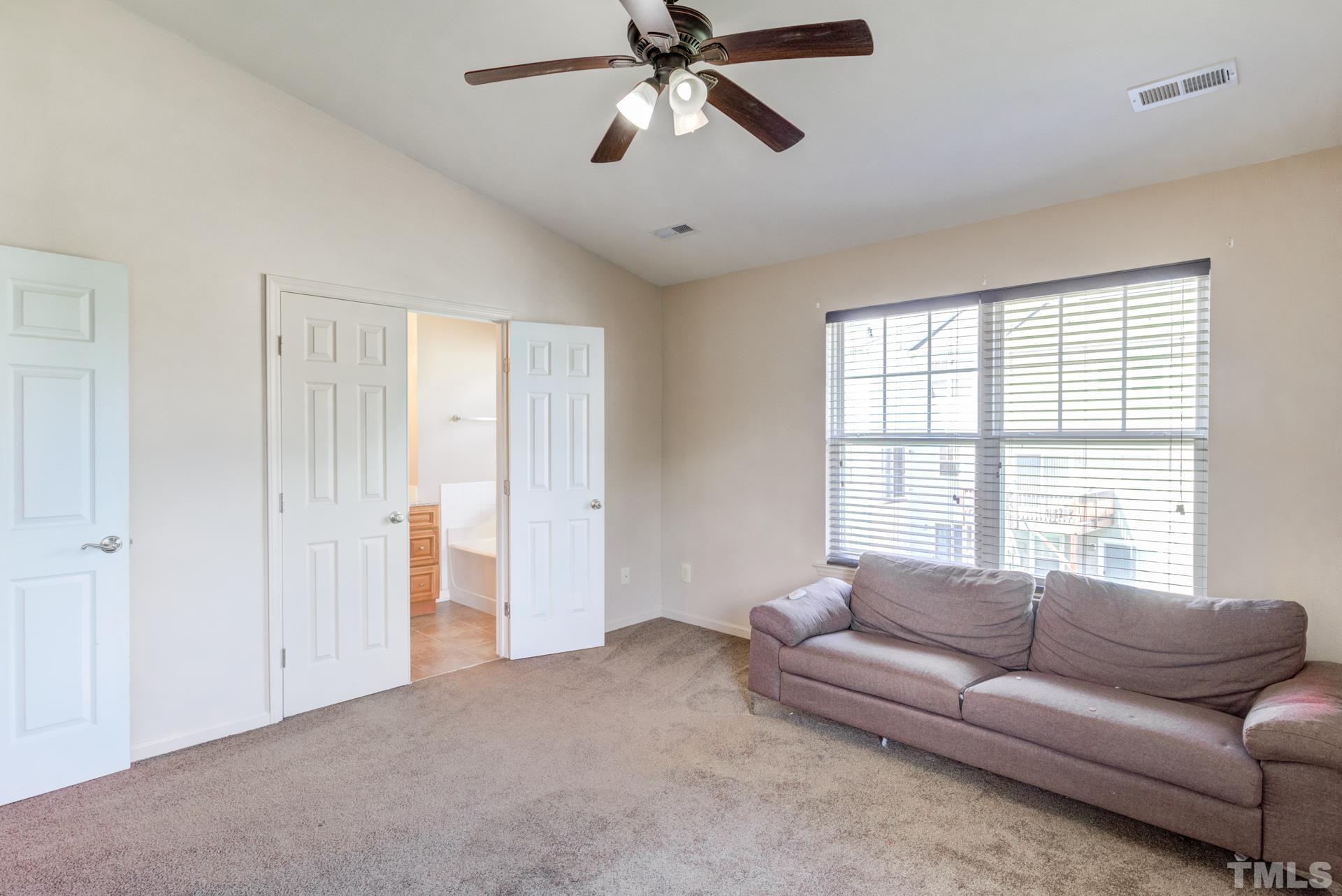 4911 Midstone Lane Raleigh, NC 27610 - Photo 21 of 28 a living room with furniture and a window