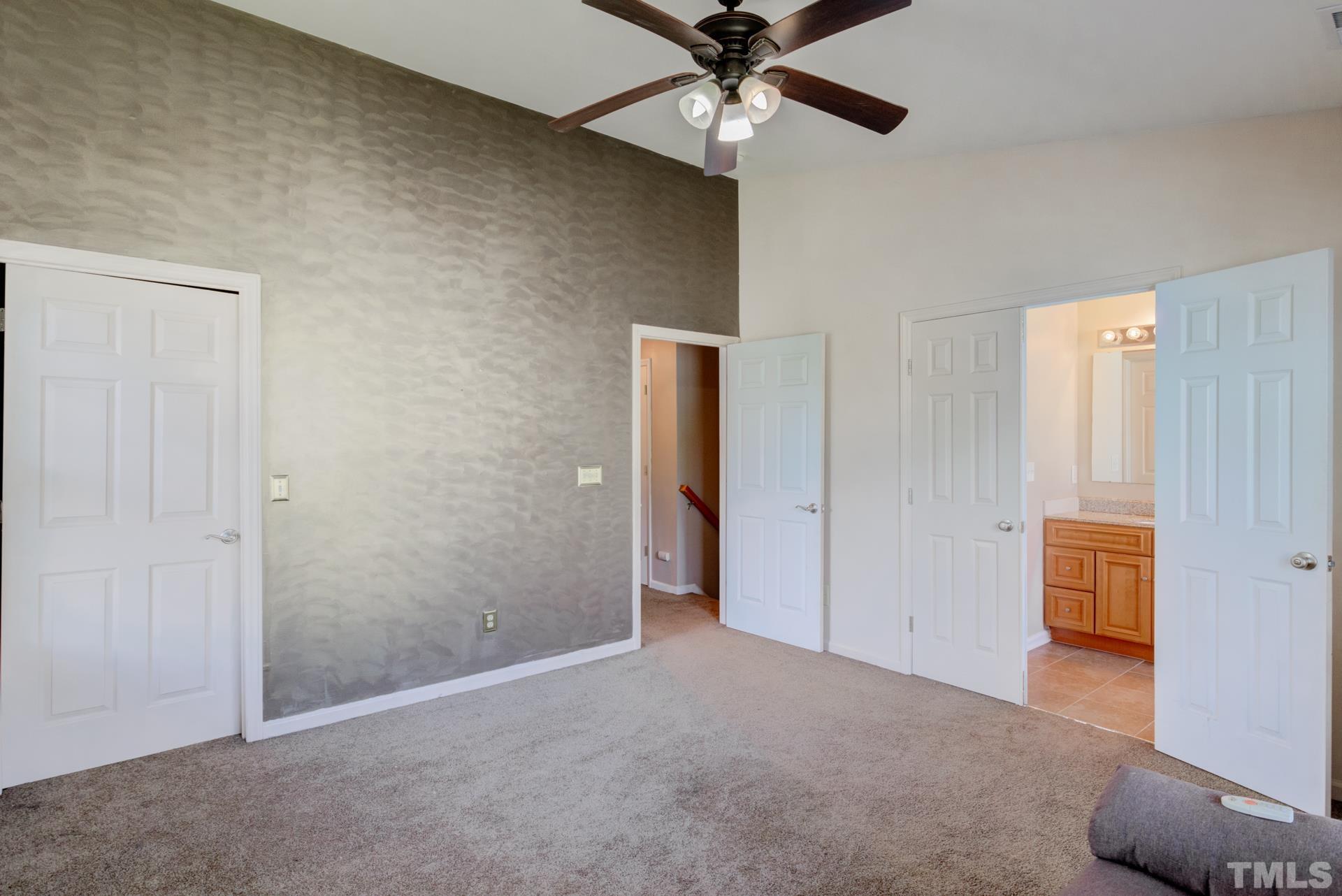 4911 Midstone Lane Raleigh, NC 27610 - Photo 22 of 28 an empty room with closet and a chandelier fan