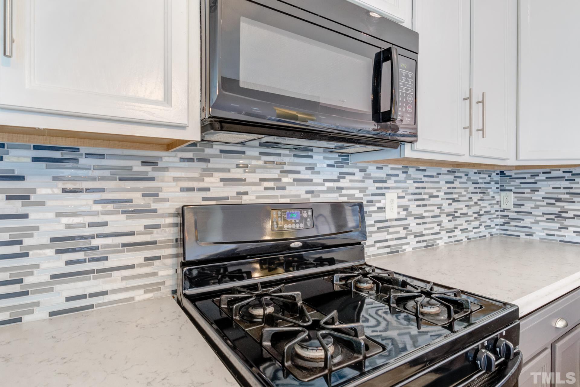 4911 Midstone Lane Raleigh, NC 27610 - Photo 8 of 28 a stove top oven sitting inside of a kitchen