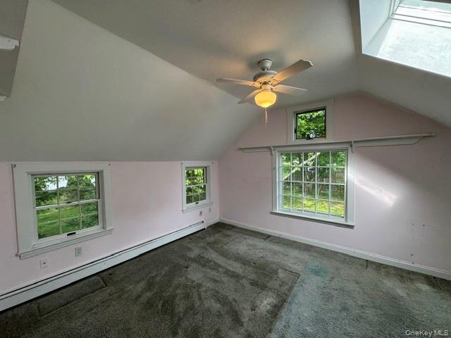 74 South Airmont Road Suffern, NY 10901 - Photo 25 of 42 Attic space featuring sloped ceilings, multiple windows with white trim, and a skylight