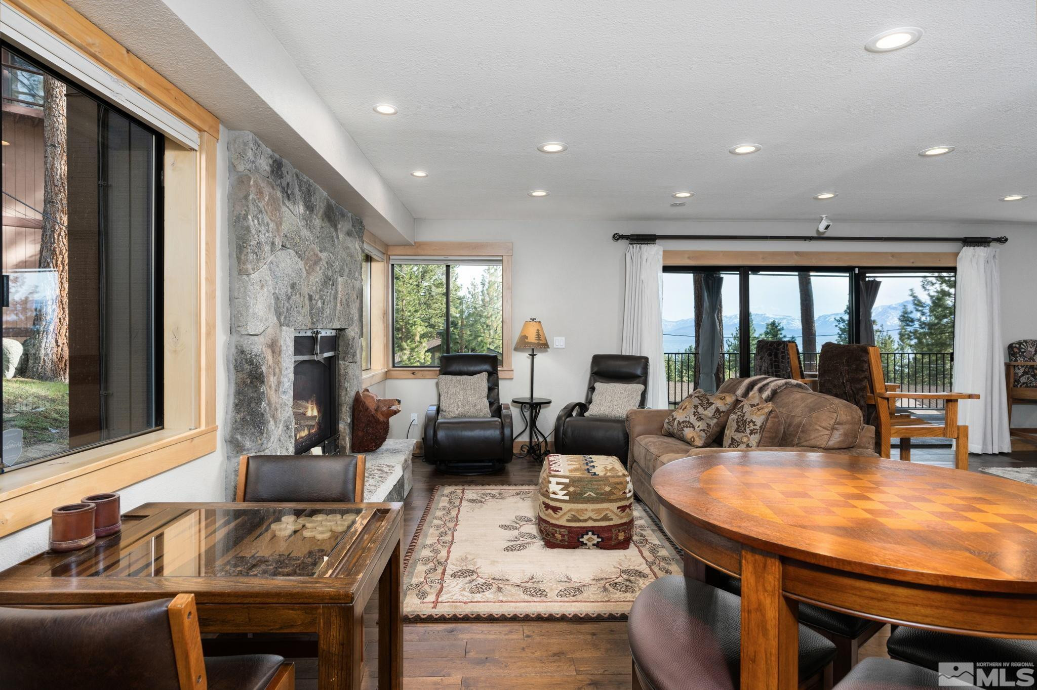 209 Sugar Zephyr Cove, NV 89448 - Photo 28 of 40 a living room with fireplace furniture and a large window