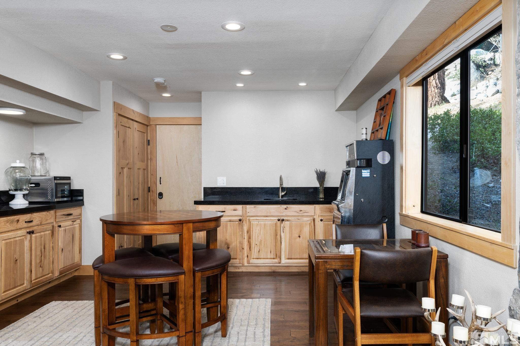 209 Sugar Zephyr Cove, NV 89448 - Photo 29 of 40 a kitchen with stainless steel appliances kitchen island granite countertop a table and chairs