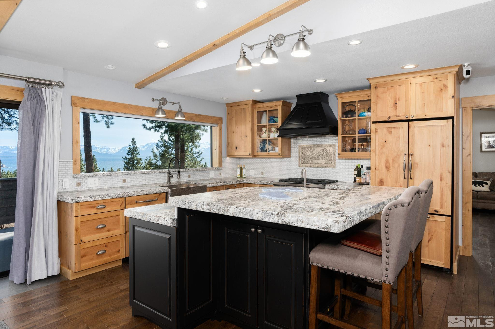 209 Sugar Zephyr Cove, NV 89448 - Photo 9 of 40 a kitchen with stainless steel appliances granite countertop a sink stove and refrigerator