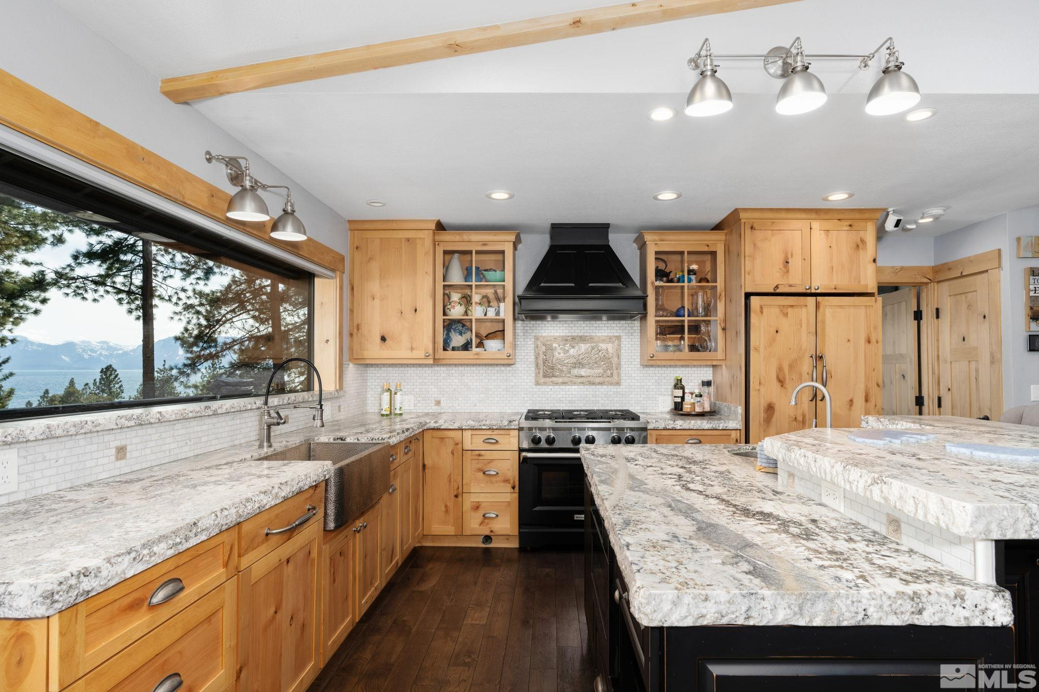 209 Sugar Zephyr Cove, NV 89448 - Photo 10 of 40 a kitchen with stainless steel appliances granite countertop sink stove and refrigerator