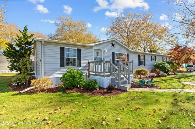 a view of a house with a chairs in a yard
