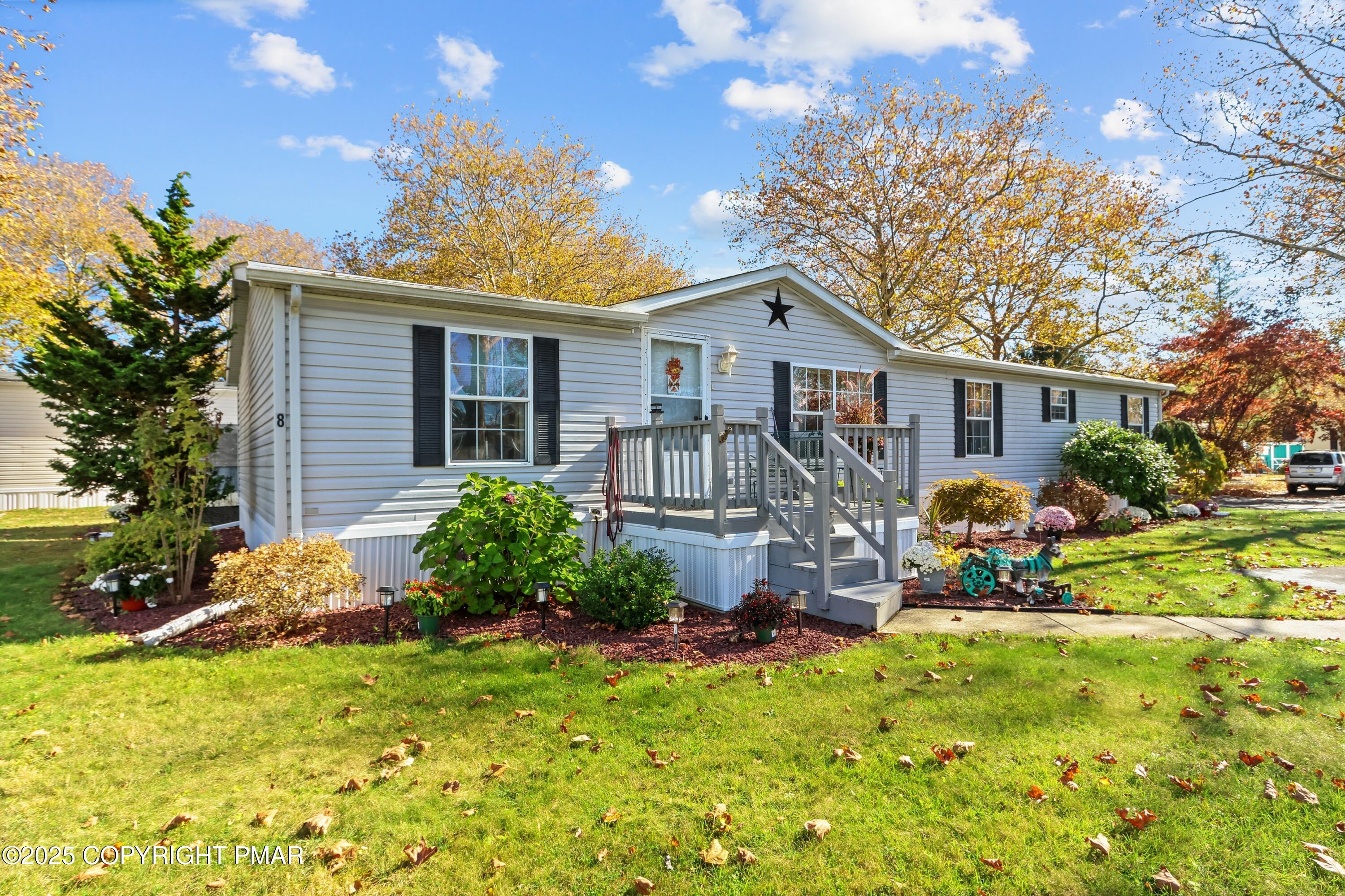 a view of a house with a chairs in a yard