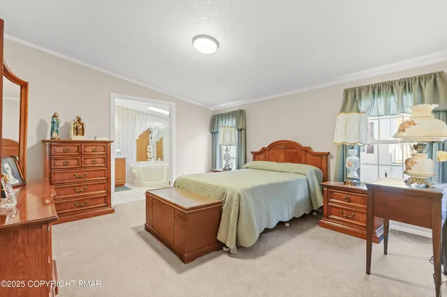 a spacious bedroom with a bed and a desk