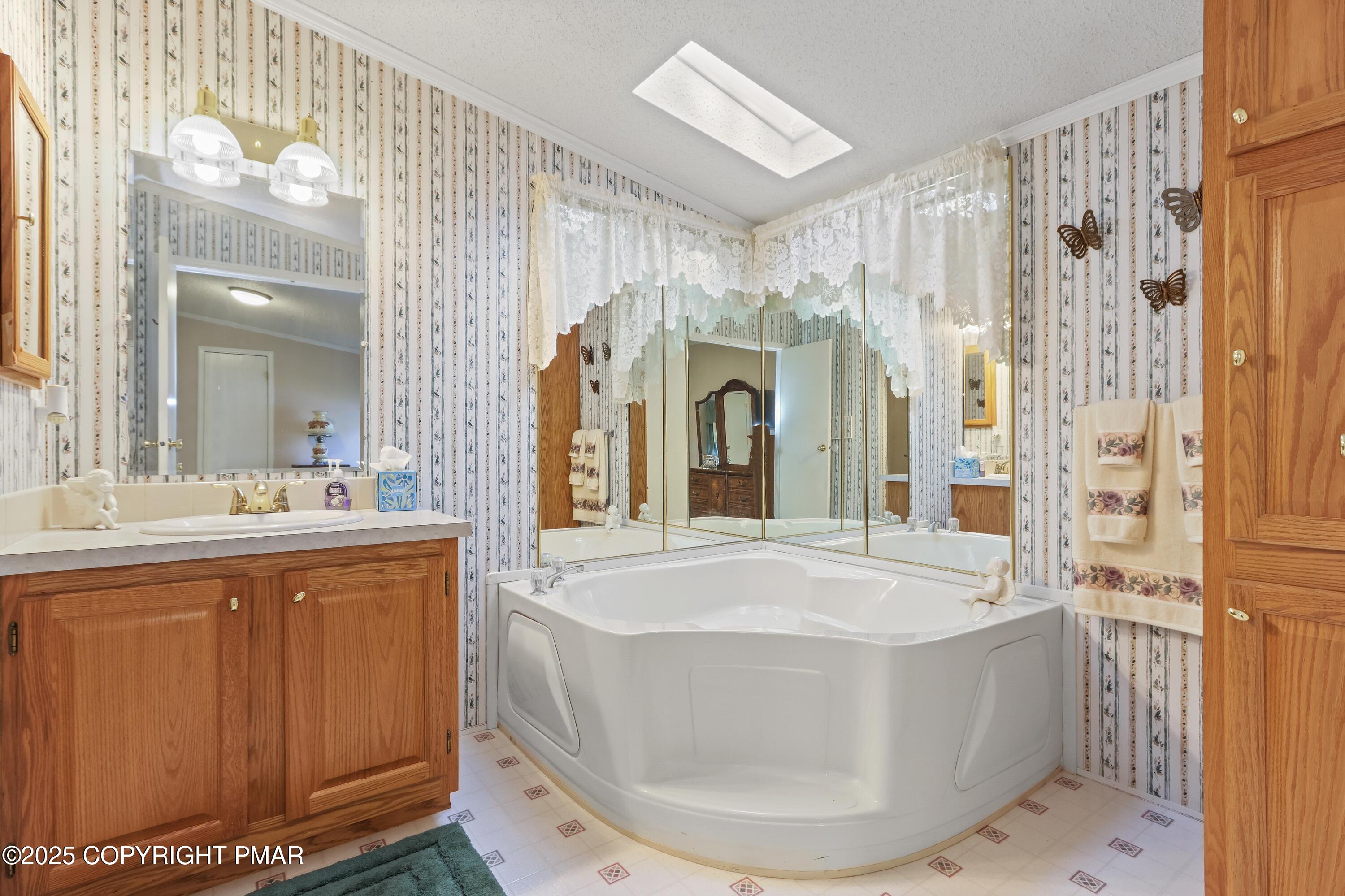 8 Cedar Court Bath, PA 18014 - Photo 25 of 35 a bathroom with a sink a mirror a bathtub and shower