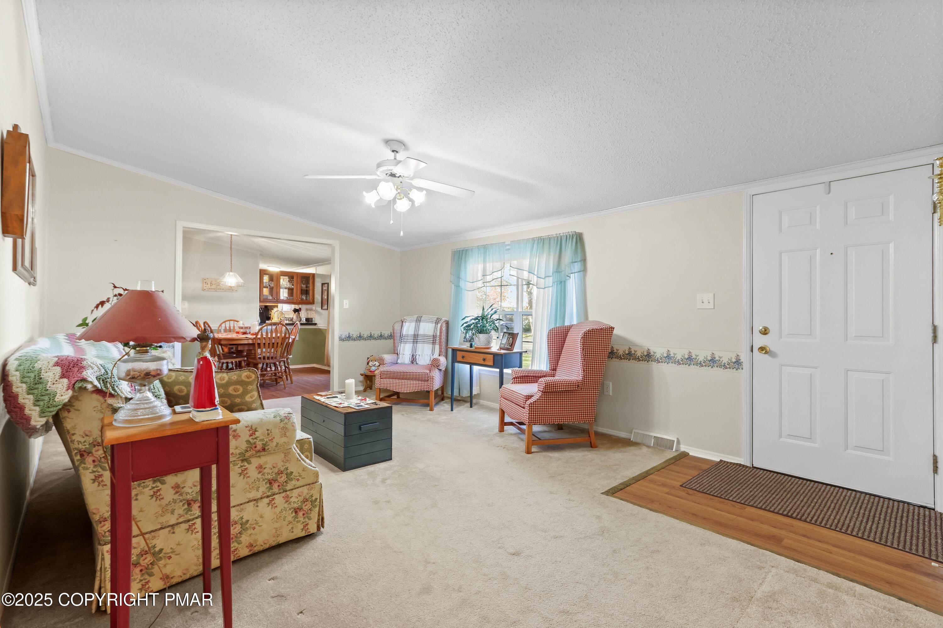 8 Cedar Court Bath, PA 18014 - Photo 7 of 35 a living room with furniture and a chandelier