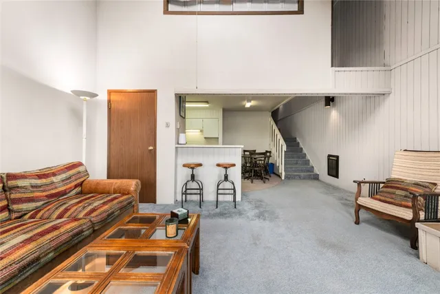 a view of a kitchen with furniture and electronic appliances