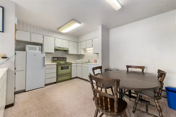 a view of kitchen with microwave and cabinets