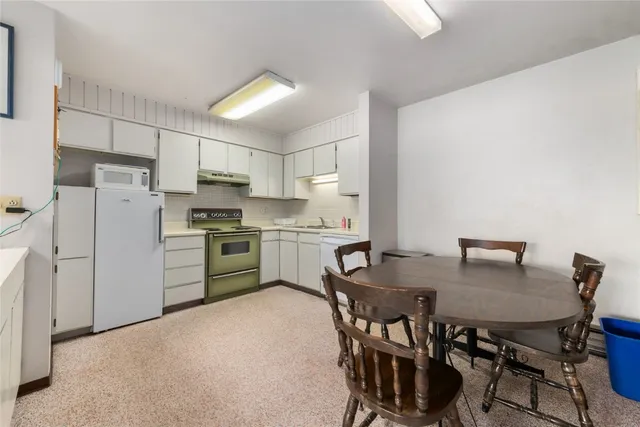 a view of kitchen with microwave and cabinets