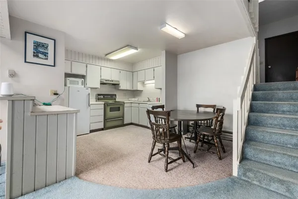 a kitchen with sink and white cabinets
