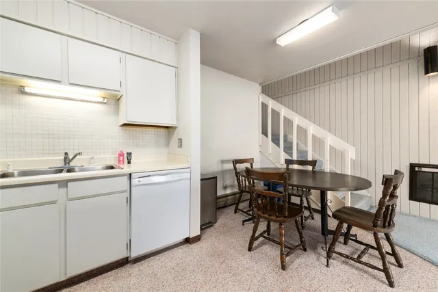 a kitchen with a stove and white cabinets