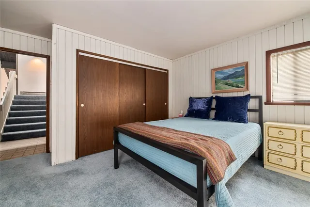 a bedroom with a bed and a table