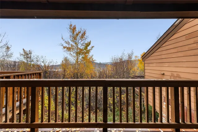 a view of a balcony with wooden fence
