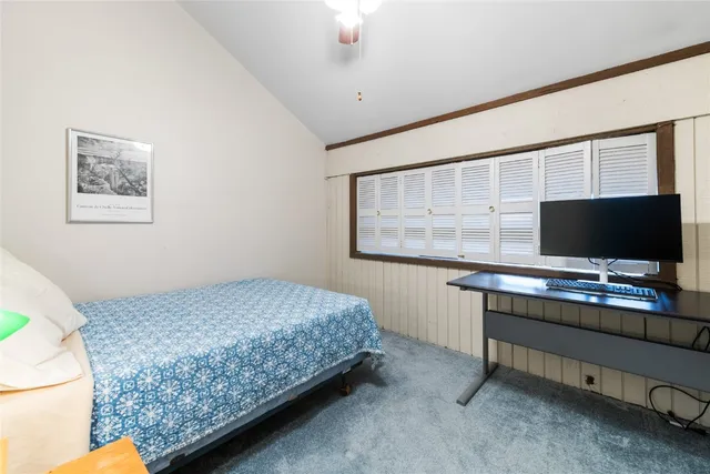 a bedroom with a bed and a desk