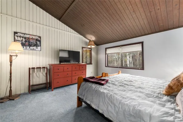 a bedroom with a bed and wall painting