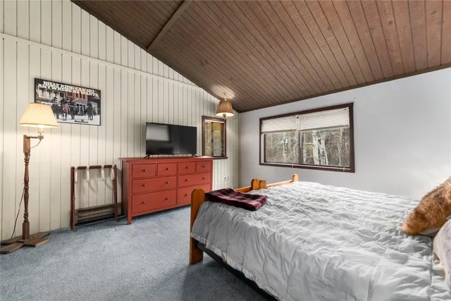 a bedroom with a bed and wall painting