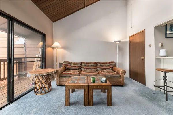 a living room with furniture and a table with wooden floor