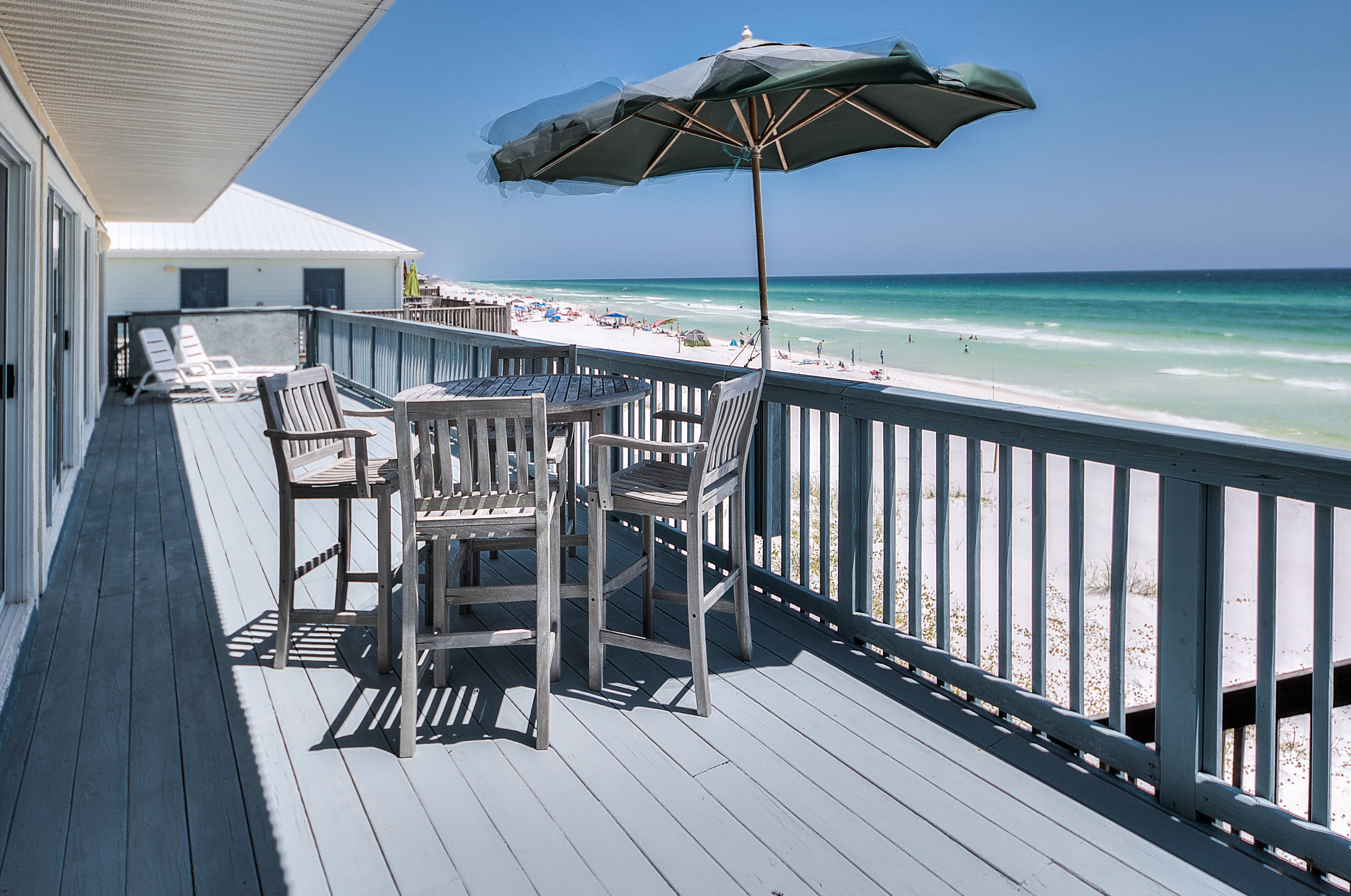 75 Fort Panic Road Santa Rosa Beach, FL 32459 - Photo 19 of 24 a view of a balcony with furniture and umbrella