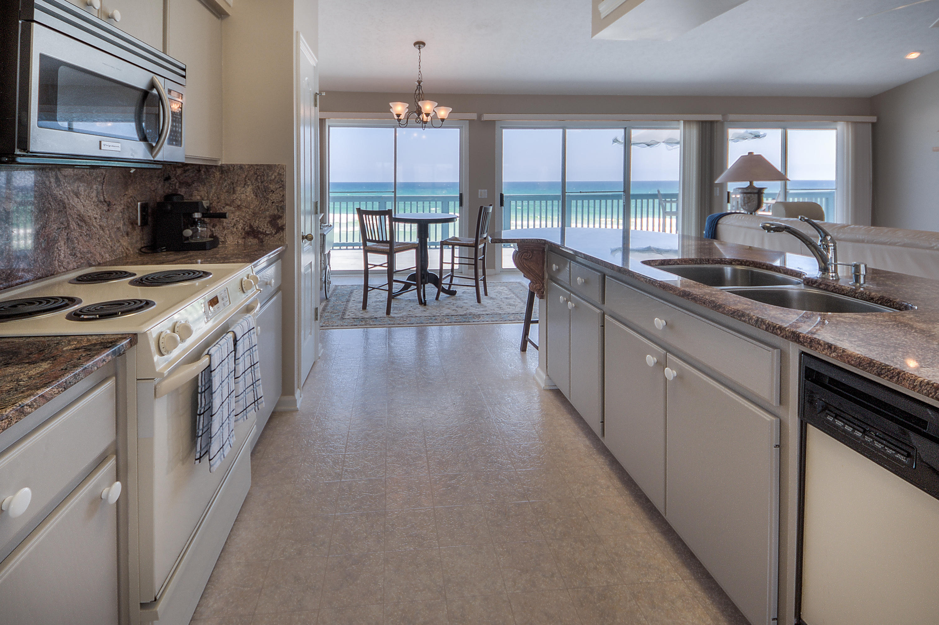 75 Fort Panic Road Santa Rosa Beach, FL 32459 - Photo 8 of 24 a kitchen with stainless steel appliances granite countertop a stove a sink and a microwave