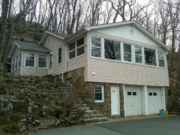 a front view of a house with a garden
