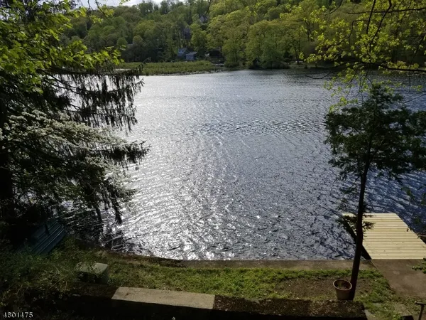 a view of a yard with wooden fence