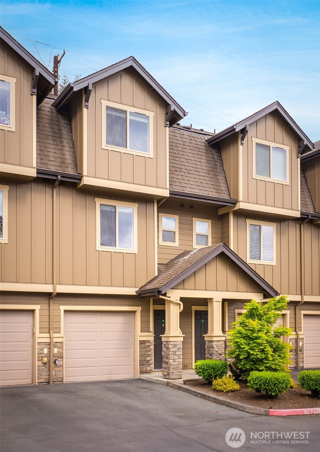 1900 Weaver Road, Unit G103 Snohomish, WA 98290 - Photo 17 of 17 a view of a white house with large windows and a small yard