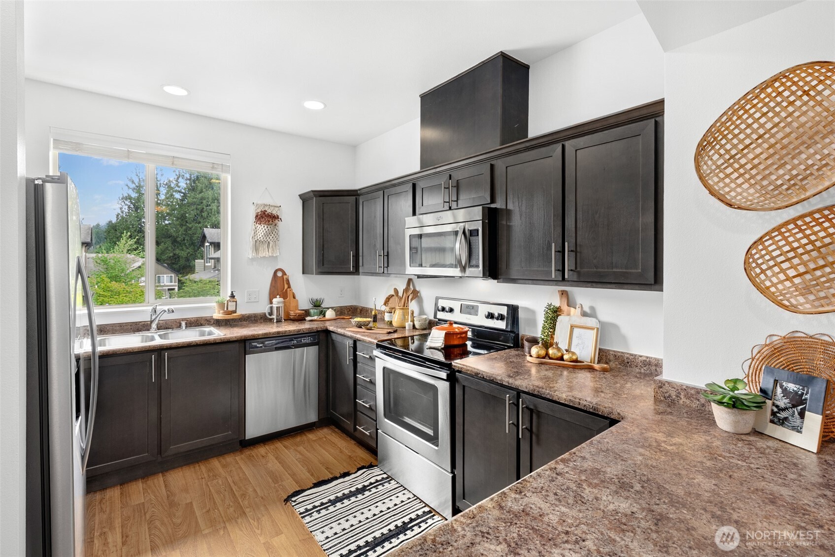 1900 Weaver Road, Unit G103 Snohomish, WA 98290 - Photo 5 of 17 a kitchen with stainless steel appliances granite countertop a sink stove microwave and refrigerator