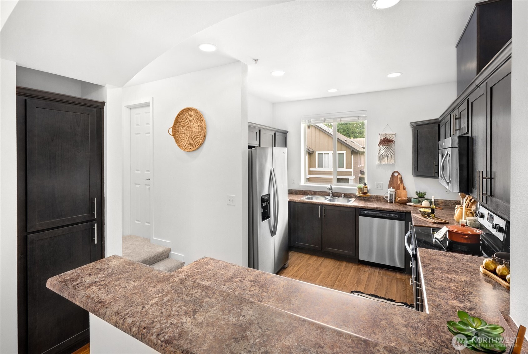 1900 Weaver Road, Unit G103 Snohomish, WA 98290 - Photo 6 of 17 a kitchen with stainless steel appliances granite countertop a refrigerator stove top oven and sink